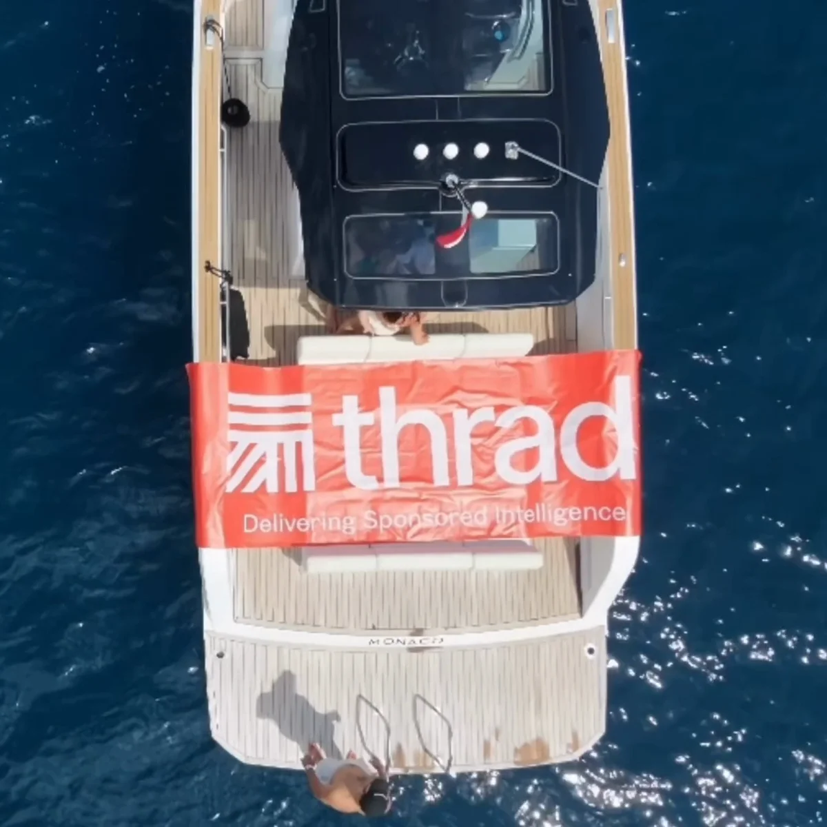 The Thrad boat from above, its banner reading Delivering Sponsored Intelligence