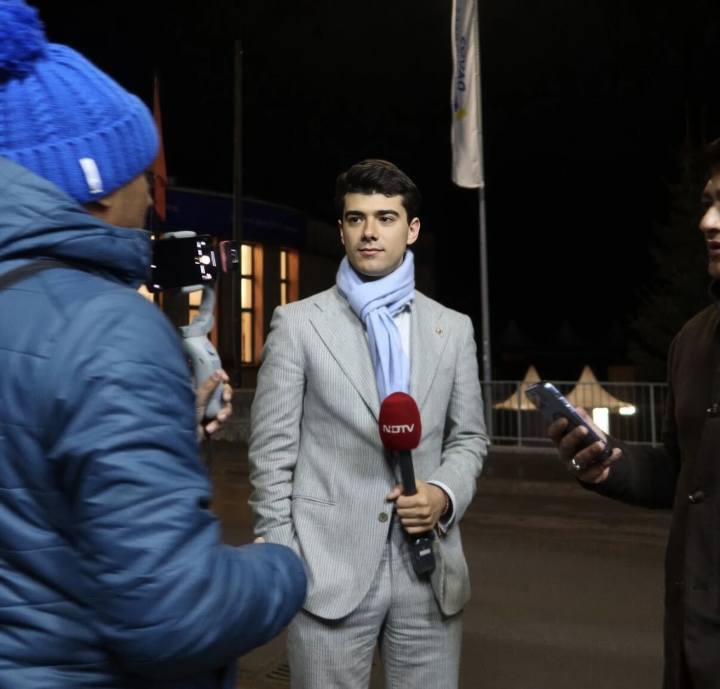 An NDTV camera crew filming the interview at night in Davos